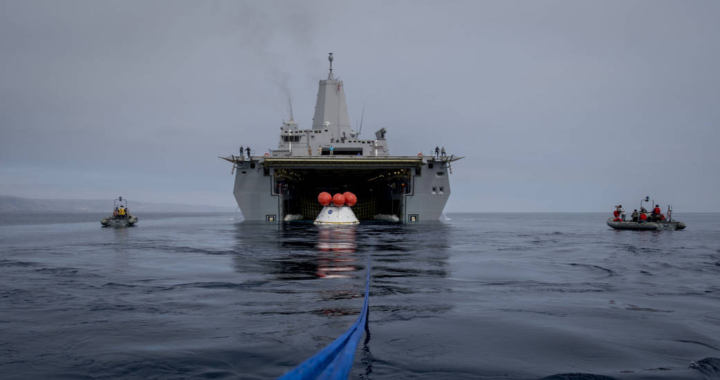 A test version of NASA's Orion spacecraft floats inside the well deck of the U.S.S. Anchorage on August 2, 2014, during recovery