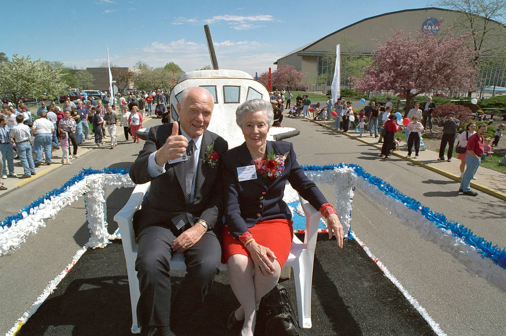 John and Annie Glenn ride a float in a parade at the NASA's Glenn Research Center.