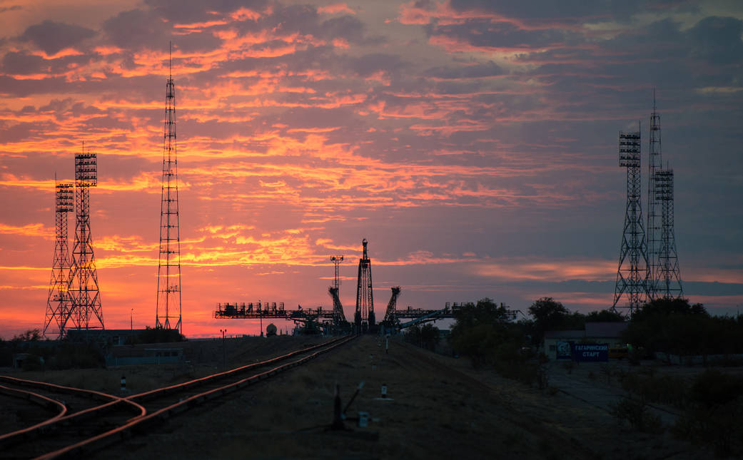 The sun rises as the Soyuz TMA-14M spacecraft is rolled out by train to the launch pad at the Baikonur Cosmodrome, Kazakhstan, S
