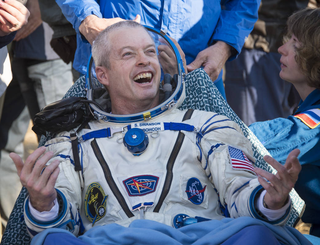 Expedition 40 Commander Steve Swanson of NASA rests in a chair outside the Soyuz Capsule just minutes after he and Flight Engine