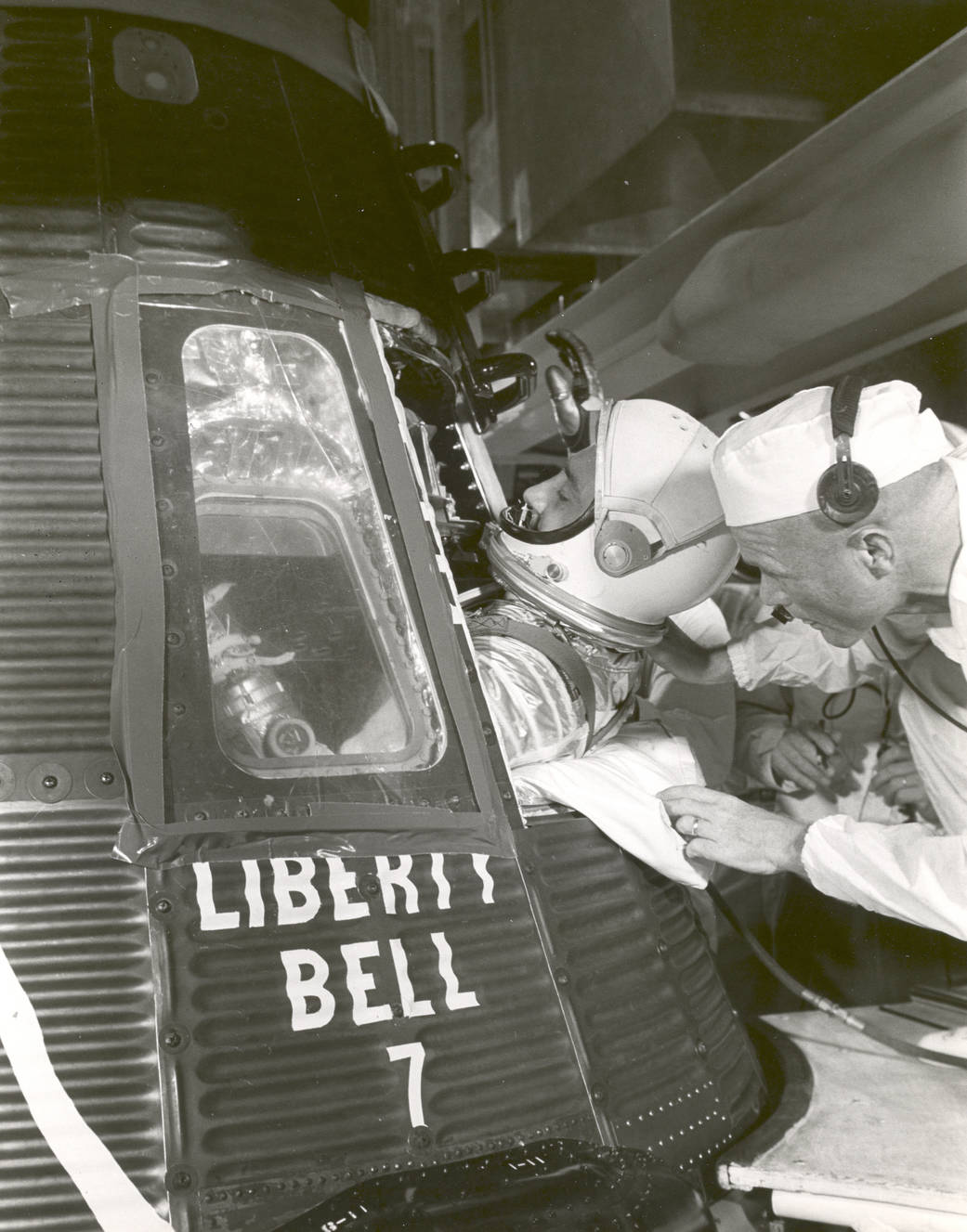 Gus Grissom is helped into the Liberty Bell 7spacecraft