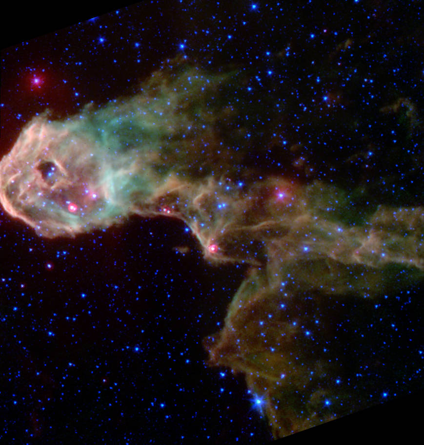 Large pale green and gold cloudlike object against black space with stars in background