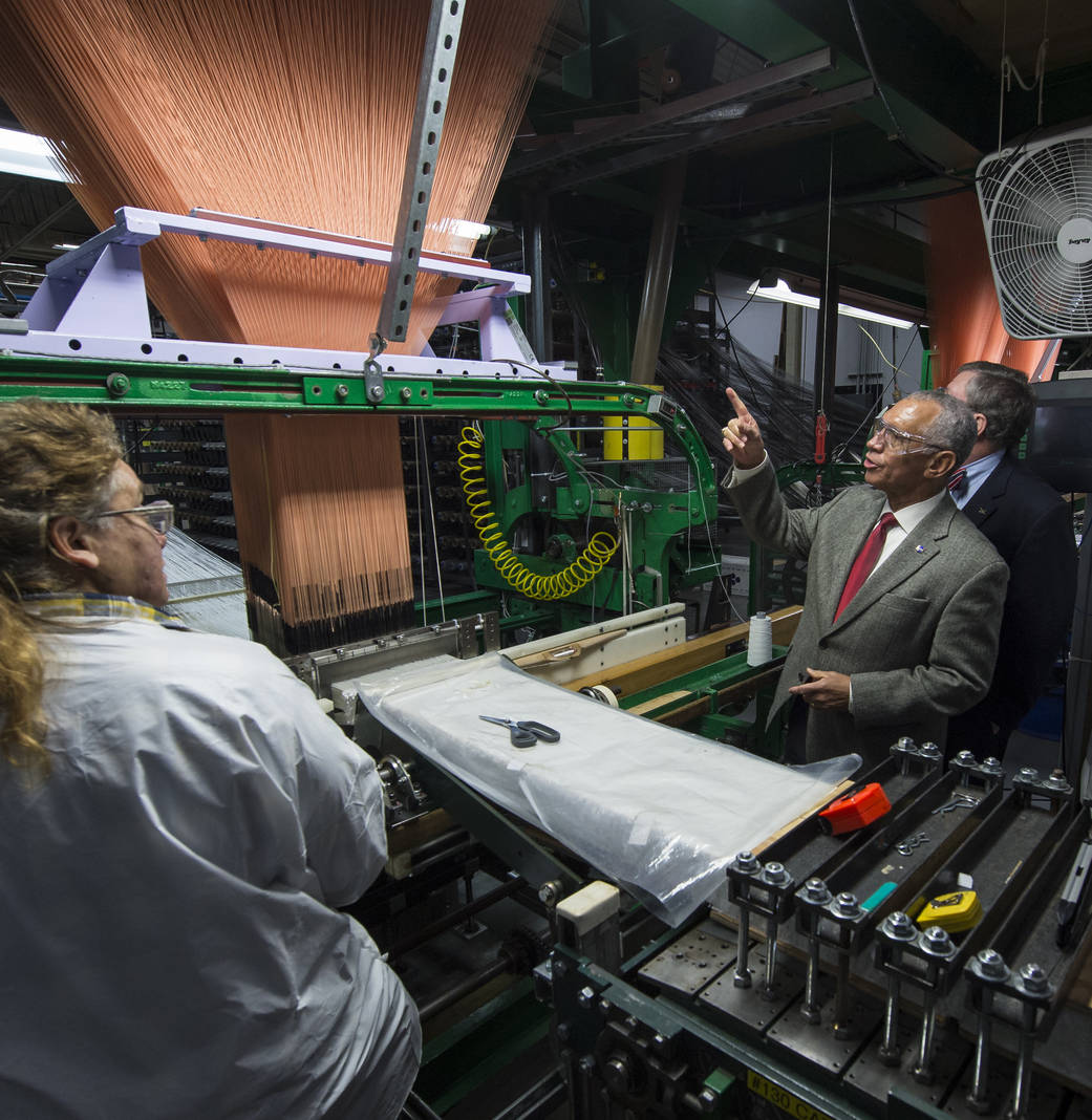 NASA Administrator Charles Bolden asks a question during a tour of the Bally Ribbon Mills (BRM) facility.