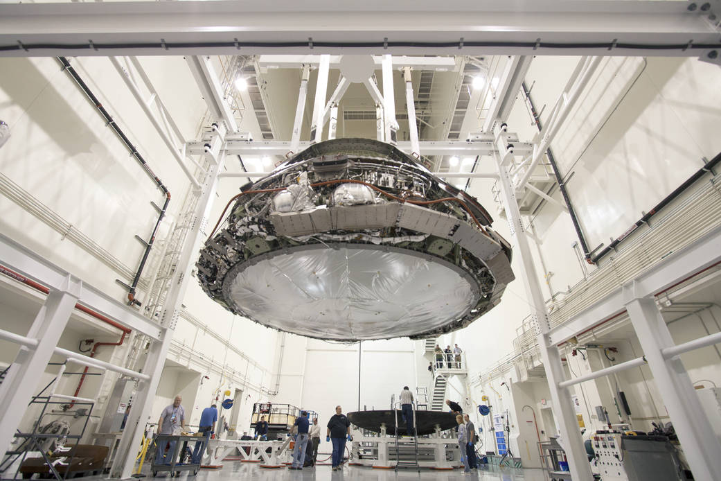 Orion spacecraft suspended in Launch Abort System Facility with heat shield removed from bottom