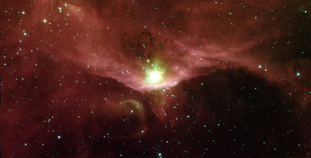 Large orange red cloud of gas with brilliant white light at center