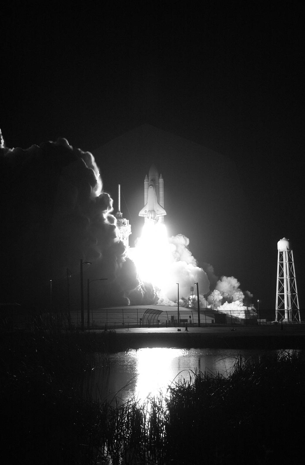 Black and white image of nighttime space shuttle launch