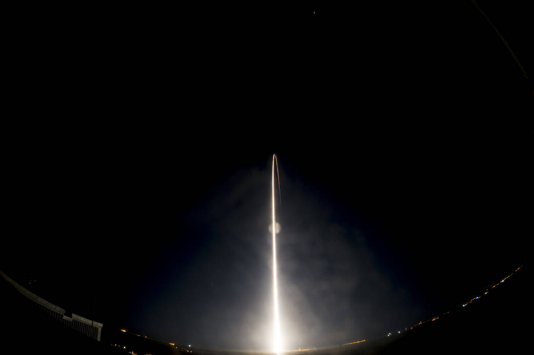 Arc of light from nighttime launch of MMS spacecraft aboard Atlas V rocket