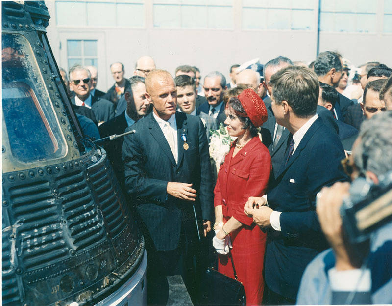 President John F Kennedy, John Glenn and Mrs. Glenn next to Friendship 7 capsule