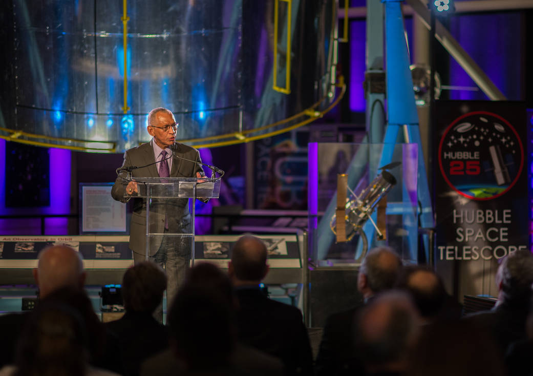 NASA Administrator Bolden speaking at podium with Hubble banner in background