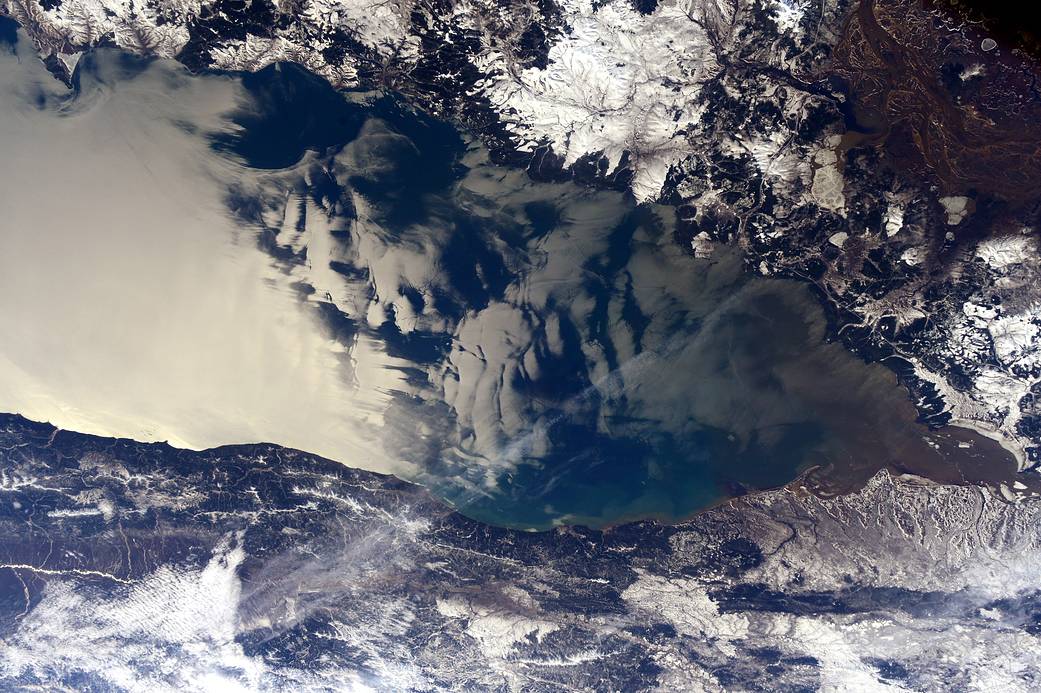 Sunglint reflects off water with clouds above