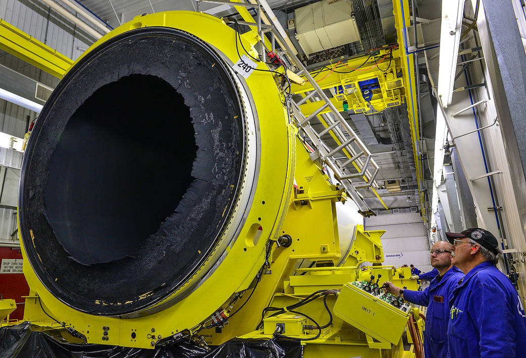 Orbital ATK technicians detach the center forward segment from the forward segment of NASA's five-segment booster. 