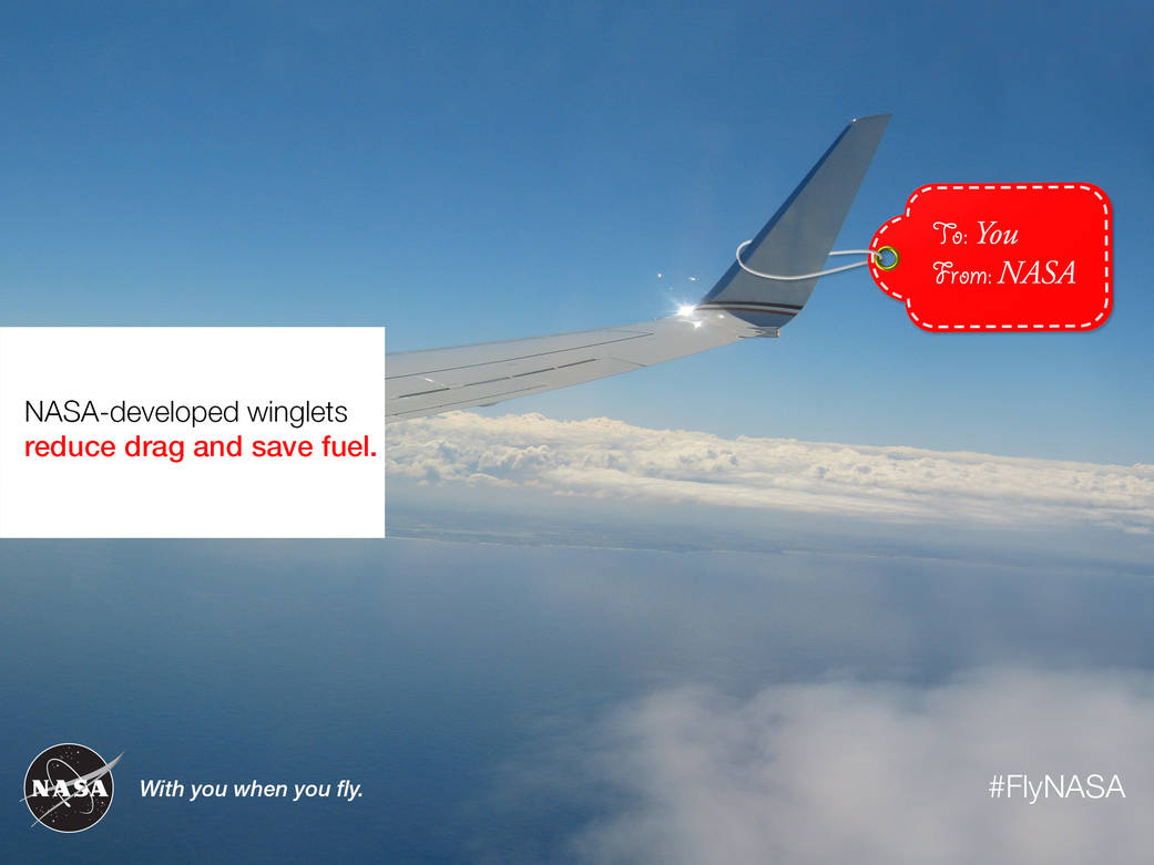 NASA-developed winglets reduce drag and save fuel. View of an airplane wing with winglets with a red gift tag that says To: You. From: NASA.