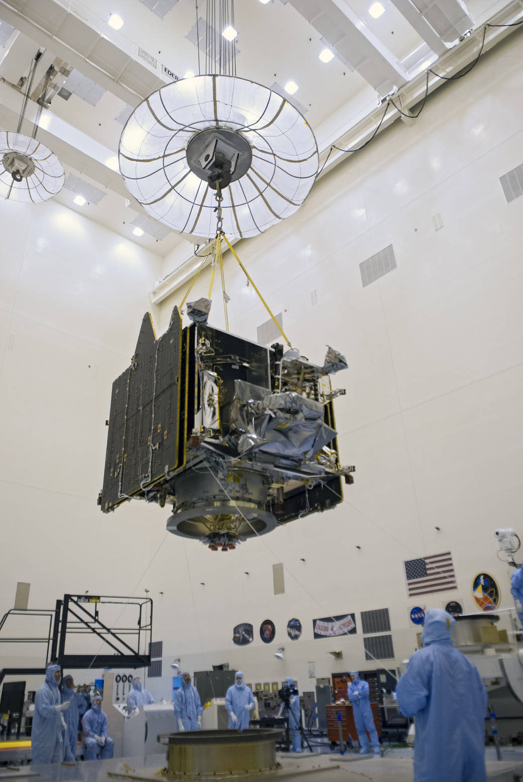 A crane lifts NASA's Mars Atmosphere and Volatile Evolution (MAVEN) spacecraft inside the Payload Hazardous Servicing Facility o