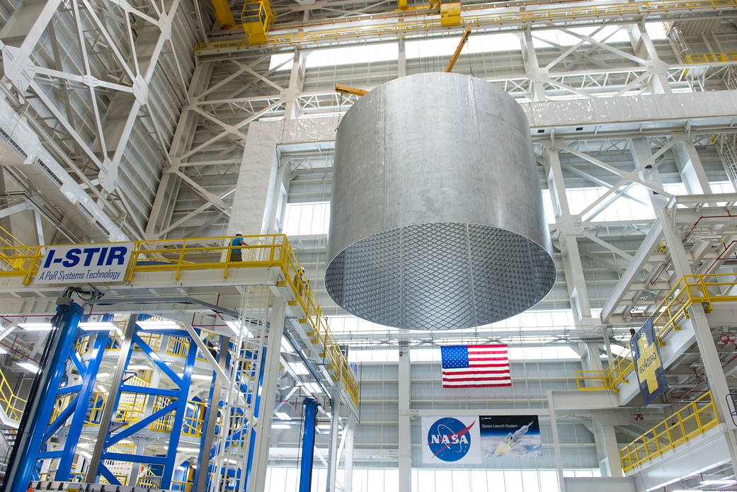 Engineers at NASA's Michoud Assembly Facility transfer a barrel section of the SLS core stage from the Vertical Weld Center. 