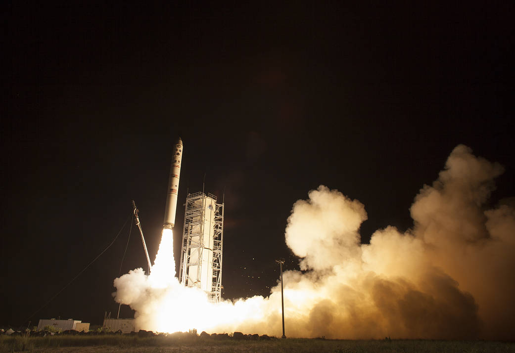 Nighttime launch of rocket carrying LADEE spacecraft with flames and clouds from base of rocket