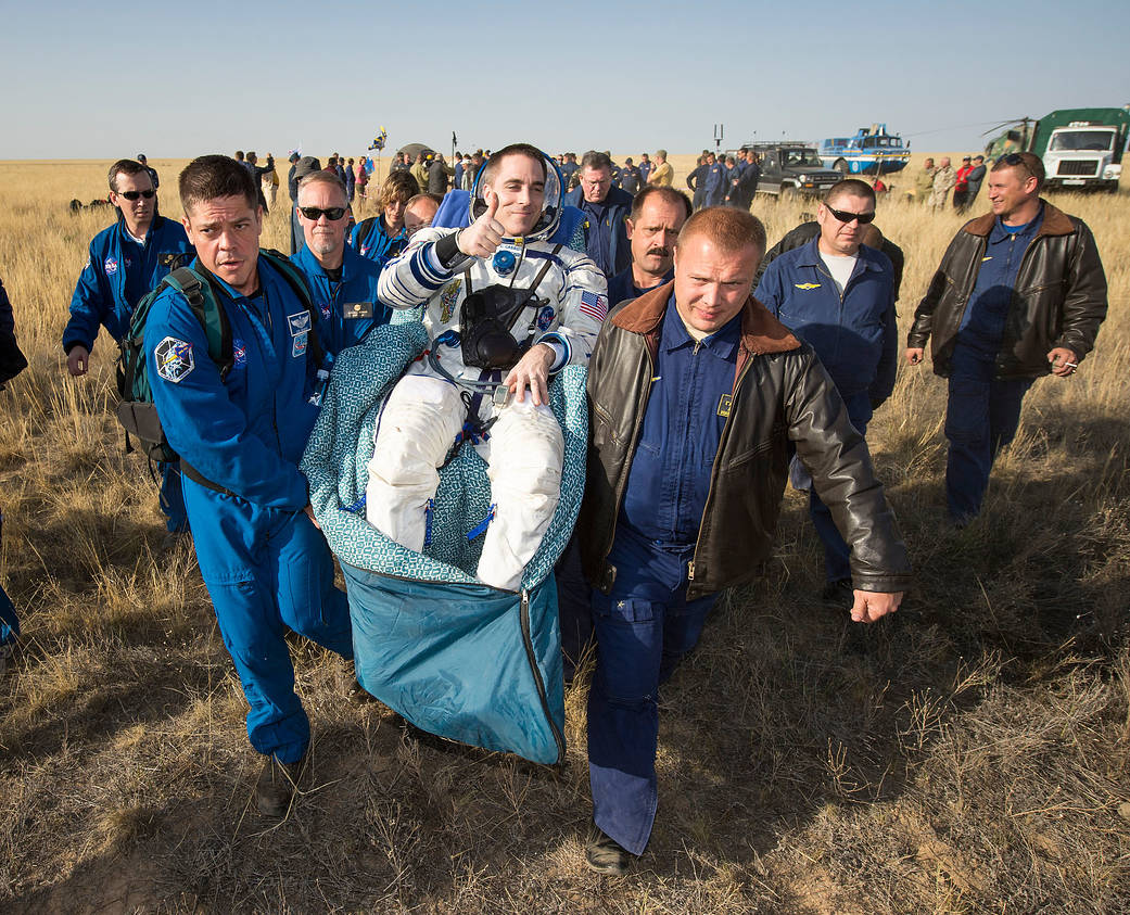 Chris Cassidy of NASA is carried to the medical tent 