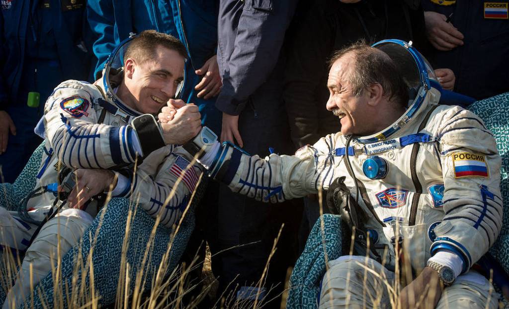 Astronaut Chris Cassidy shakes the hand of cosmonaut Pavel Vinogradov