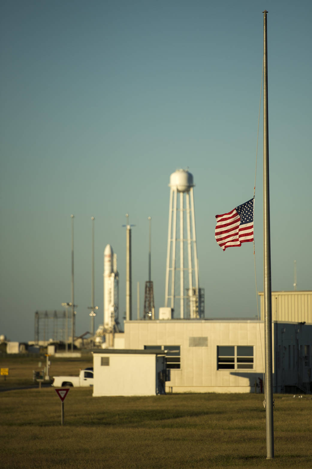 A United States flag is flown at half-staff just outside the Mid-Atlantic Regional Spaceport (MARS) Pad-0A with the Orbital Scie