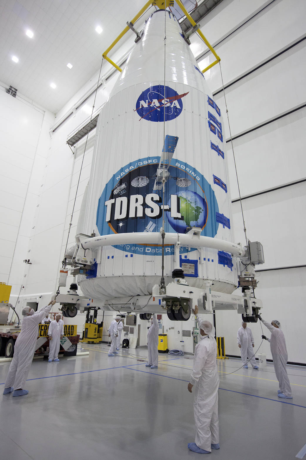 NASA's Tracking and Data Relay Satellite, or TDRS-L, spacecraft has been encapsulated in its payload fairing. It is being lifted