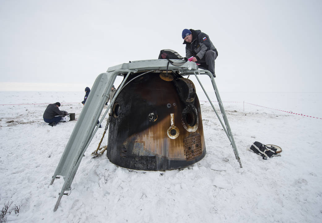 Engineers document cargo as it is unloaded from the Soyuz TMA-10M spacecraft after it landed with Expedition 38 Commander Oleg K