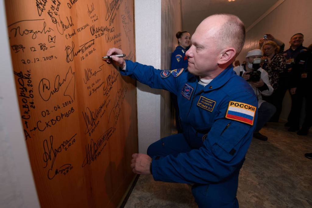 Cosmonaut Oleg Artemyev Signs Cosmonaut Hotel Door