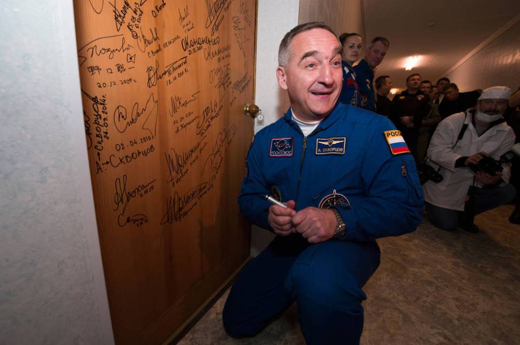 Soyuz Commander Alexander Skvortsov Signs Door at Cosmonaut Hotel