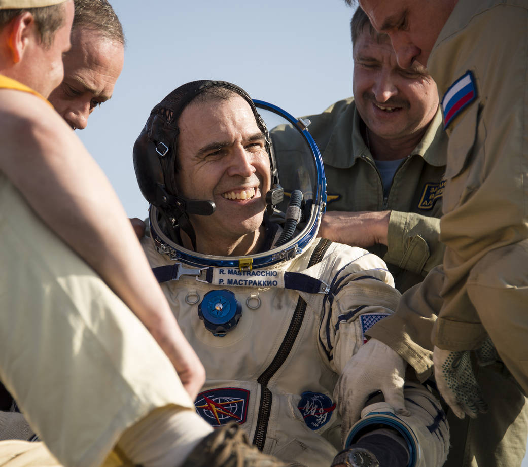 Expedition 39 Flight Engineer Rick Mastracchio of NASA is helped out of the Soyuz capsule 