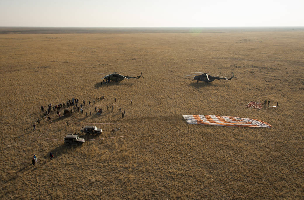 Ground support personnel are seen at the landing site after the Soyuz TMA-12M spacecraft landed with Expedition 40 Commander Ste