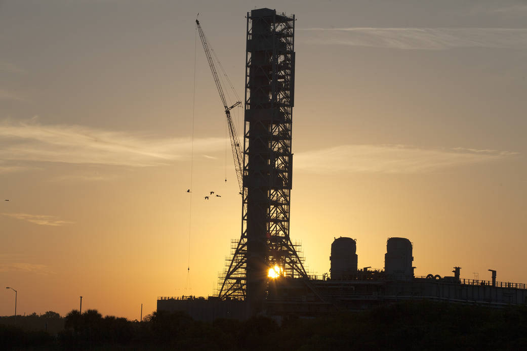 A sunrise casts a golden glow on NASA's Mobile Launcher in the Launch Complex 39 area at NASA's Kennedy Space Center in Florida.