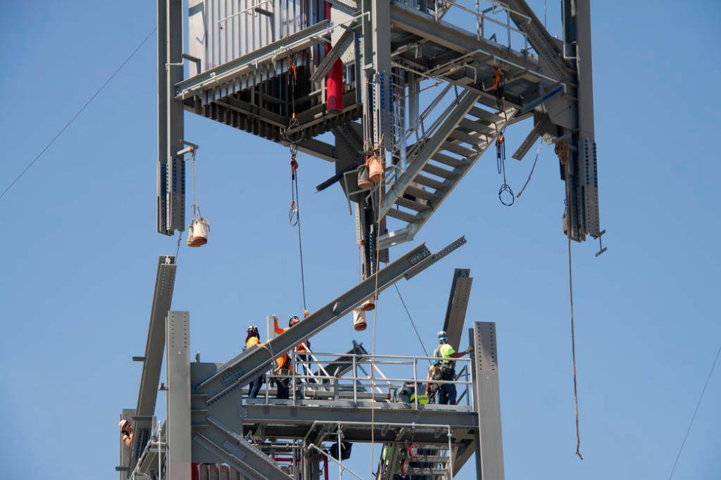Workers Guide Fourth Tier Into Place