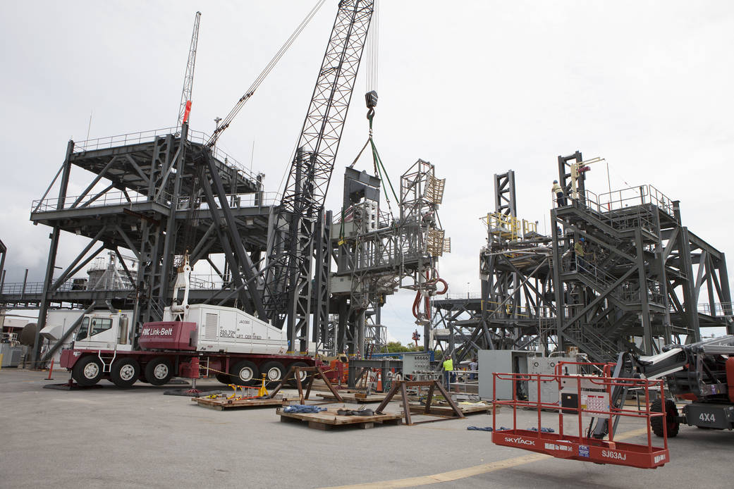 A heavy-lift crane lifts the Interim Cryogenic Propulsion Stage Umbilical at the Launch Equipment Test Facility