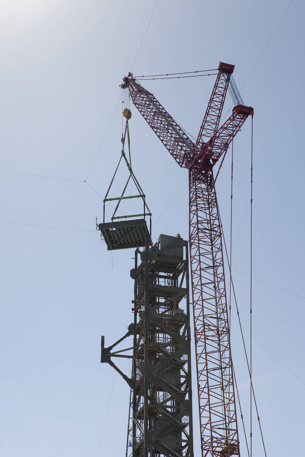 Crane lifts roof into place on Crew Access Tower