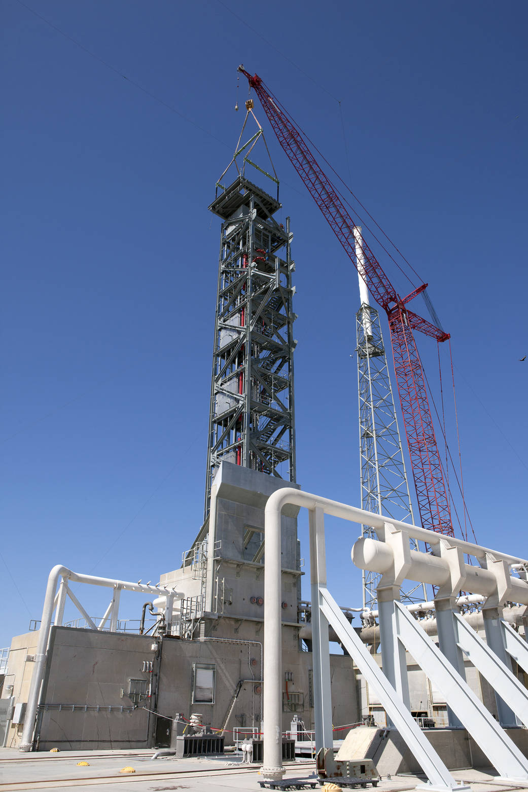 Crane lifts roof into place on Crew Access Tower