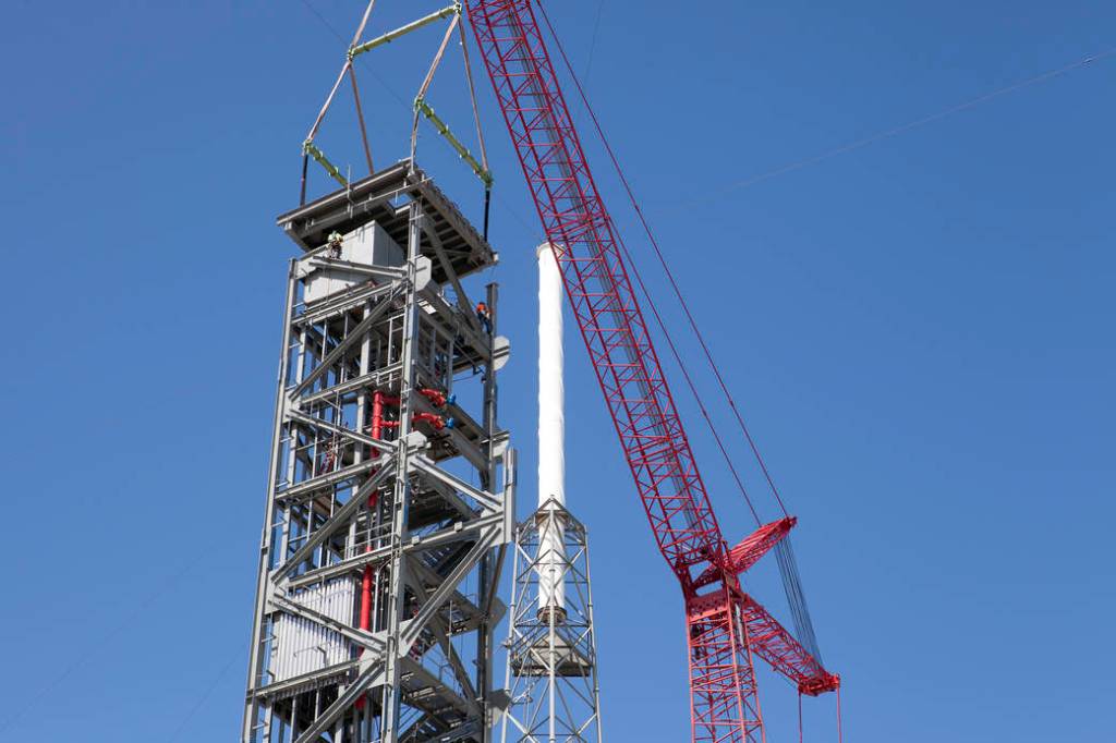 Workers Guide Roof Into Place on Crew Access Tower
