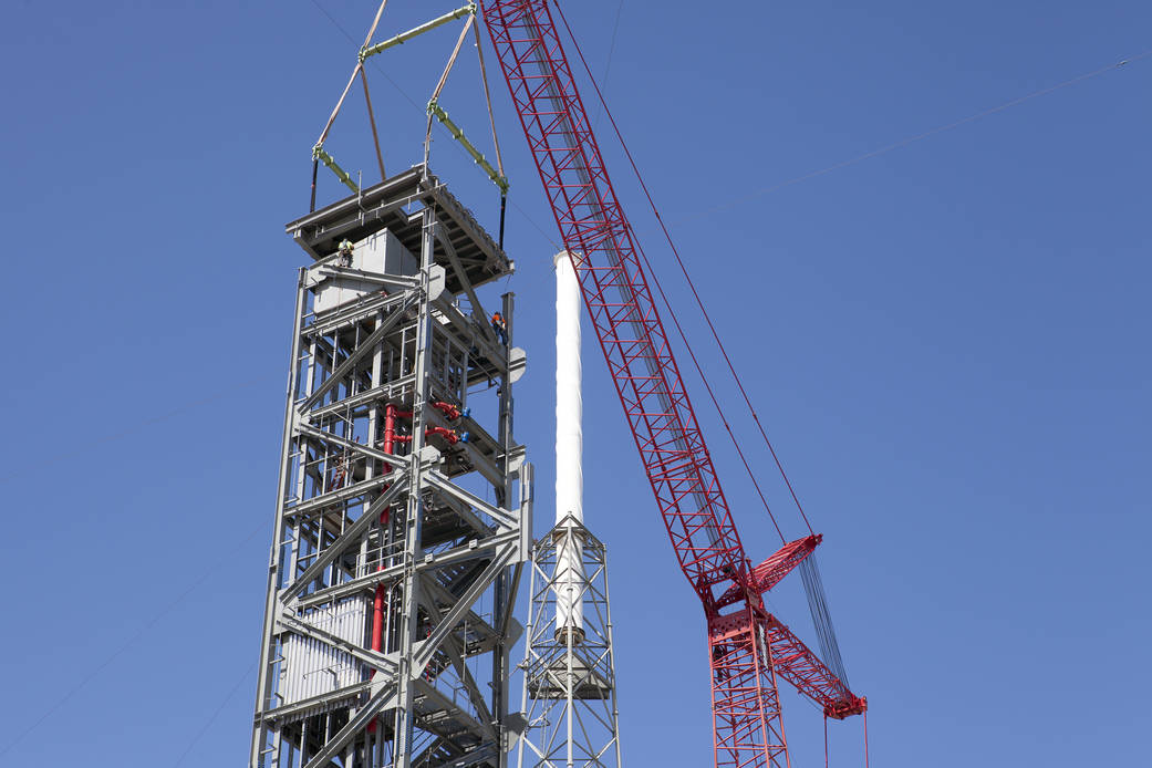 Crane lifts roof into place on Crew Access Tower