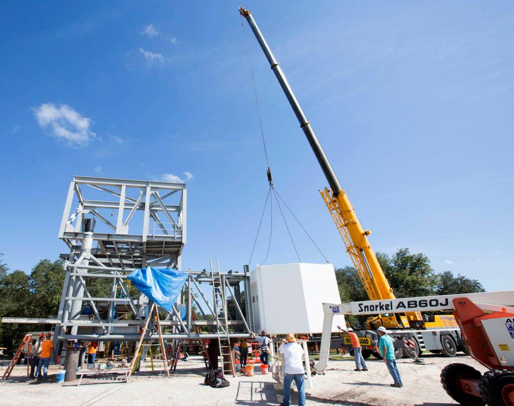 Crane Lifts White Room Into Place