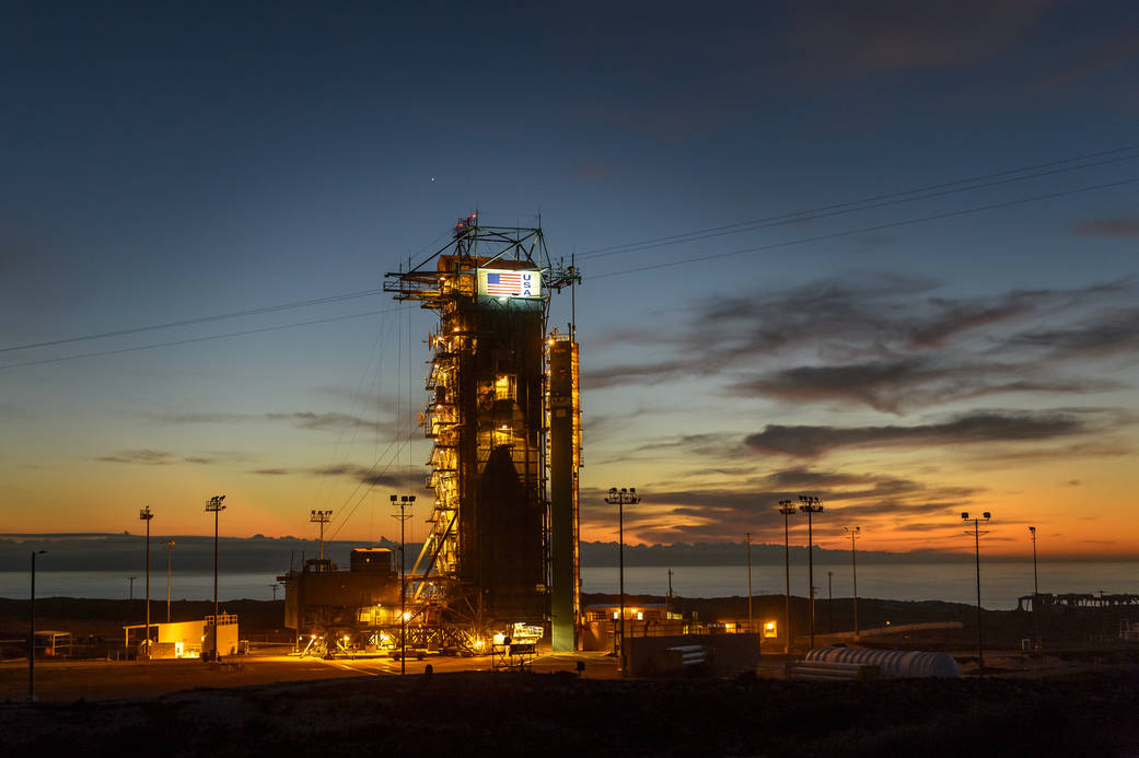The sun sets behind Space Launch Complex 2 (SLC-2) with the Delta II rocket and the Soil Moisture Active Passive (SMAP).