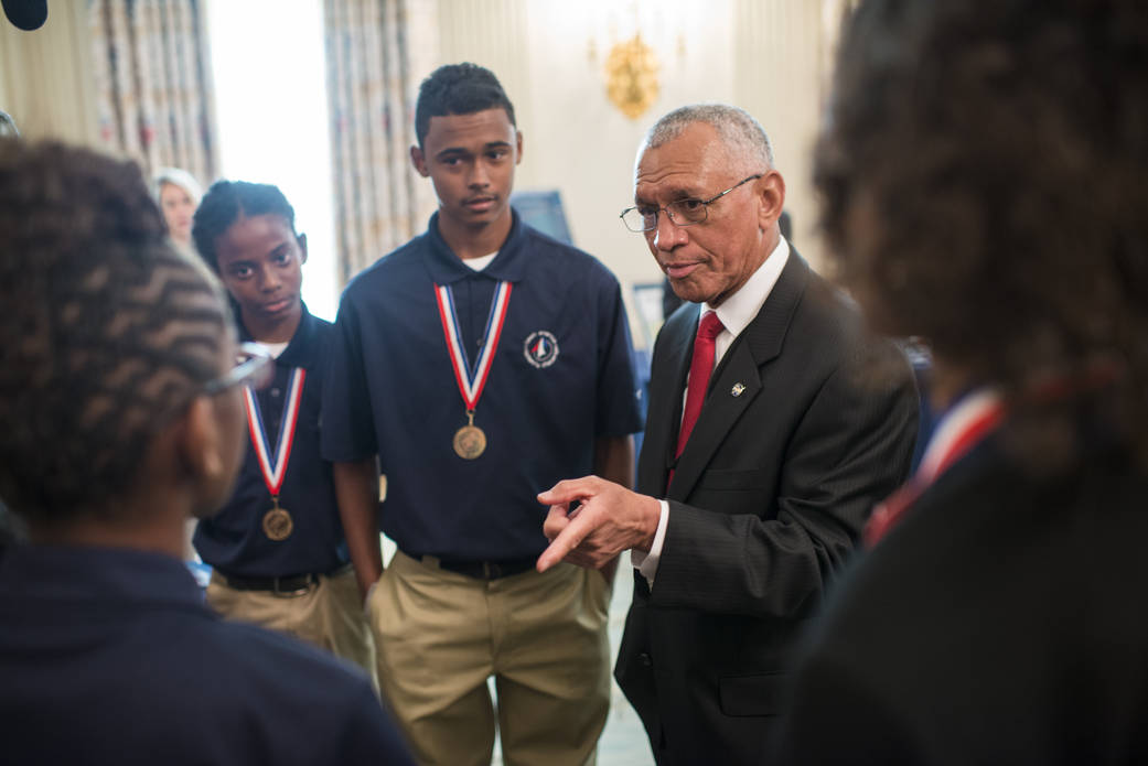 NASA Administrator Bolden speaks with students wearing medals