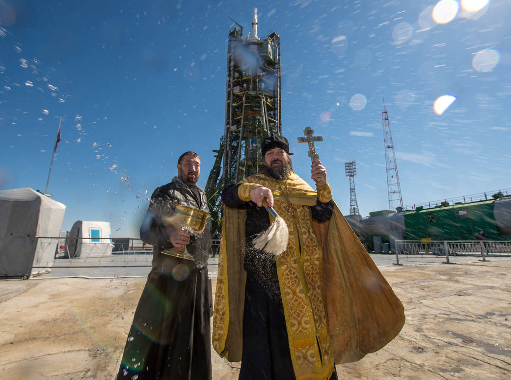 An Orthodox Priest Blesses Members of the Media