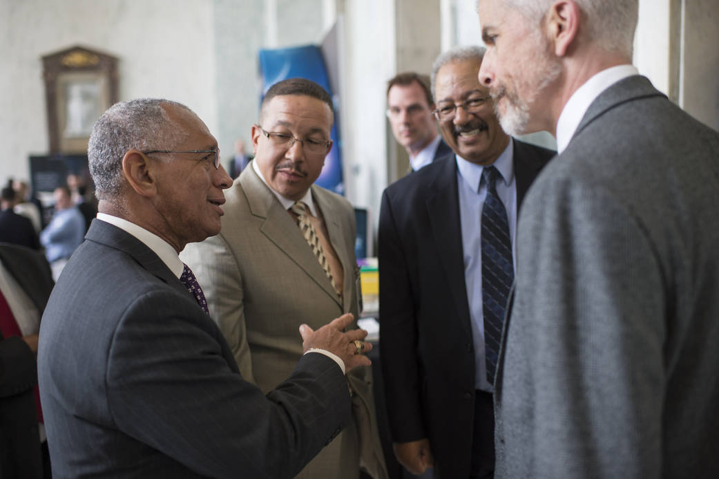 Charles Bolden conversing in the Rayburn House Office Building in Washington.