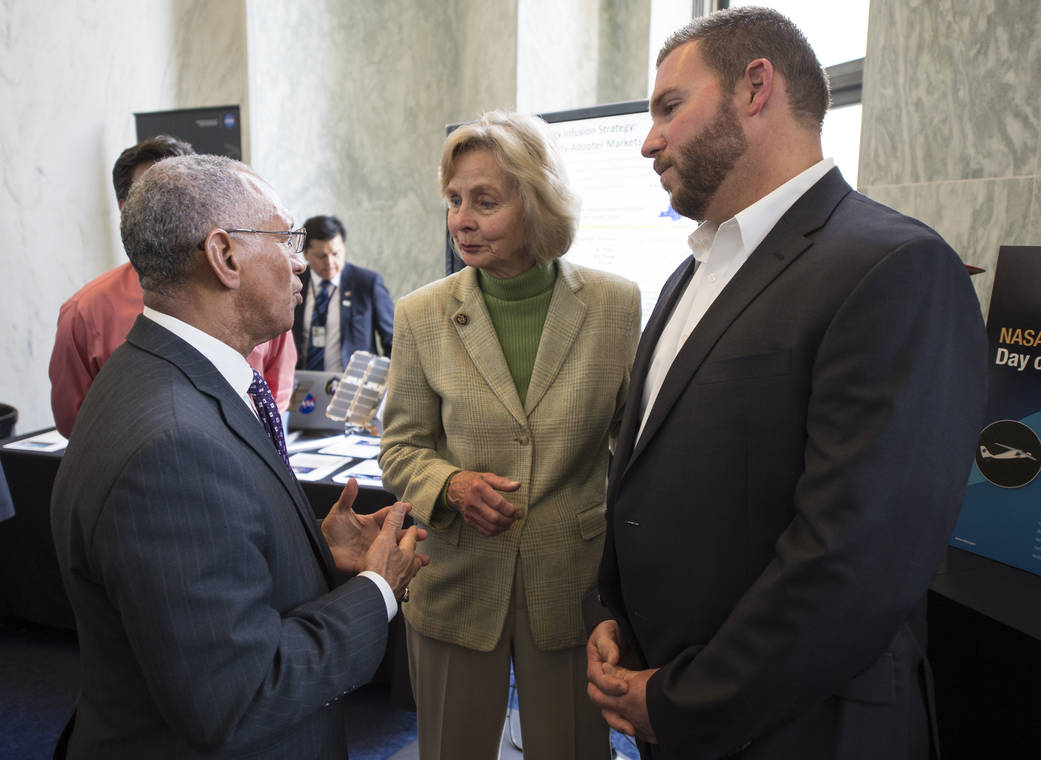 Charles Bolden conversing in the Rayburn House Office Building in Washington.