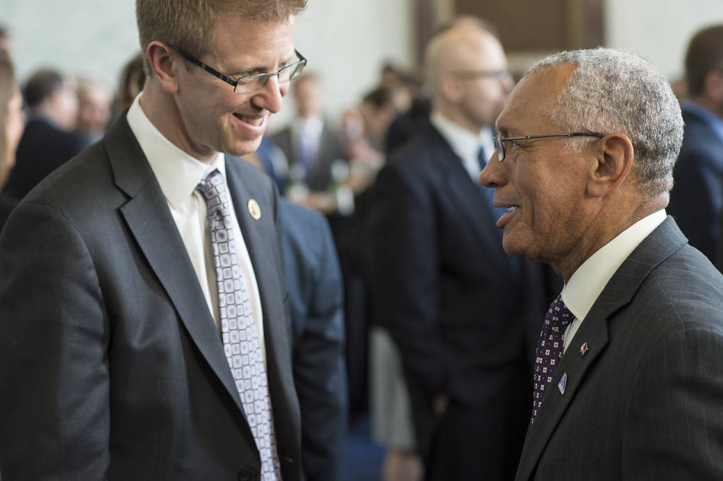 Charles Bolden conversing in the Rayburn House Office Building in Washington.