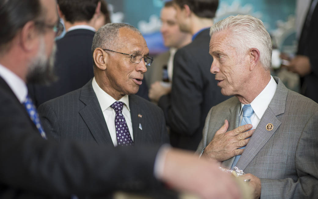 Charles Bolden conversing in the Rayburn House Office Building in Washington.