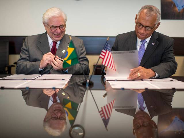 Brazilian Space Agency (AEB) President José Raimundo Braga Coelho, left,  and NASA Administrator Charles Bolden sign agreements 