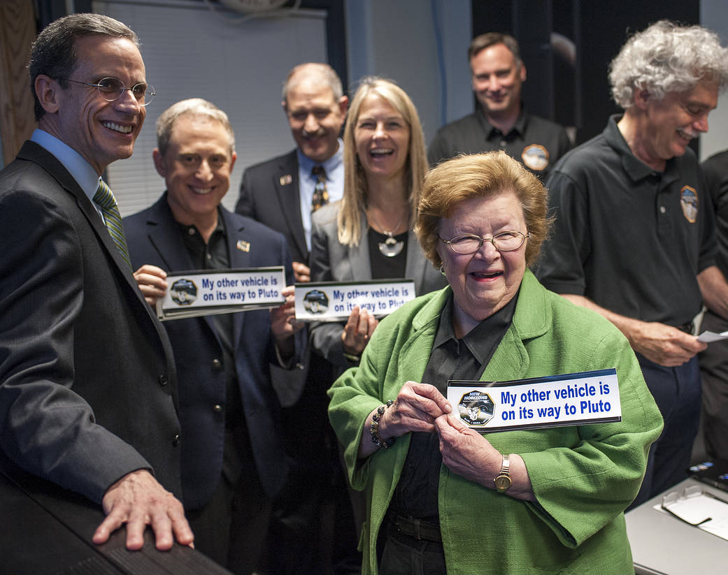 Sen. Barbara Mikulski, D-Md. holds a bumper sticker given to her by members of the New Horizons team at the Johns Hopkins.