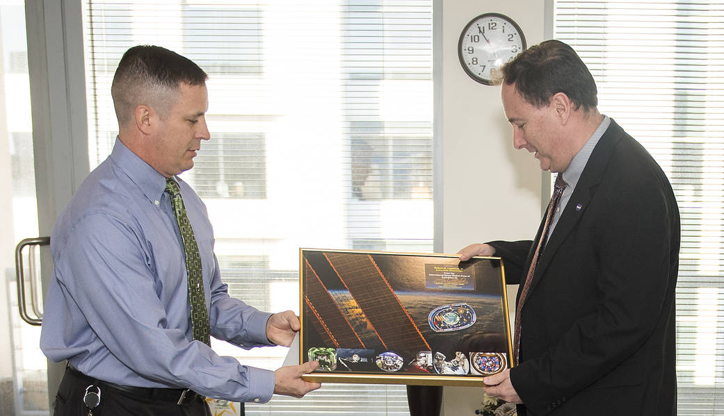 Astronaut Jack Fischer and Acting NASA Administrator Lightfoot with montage plaque