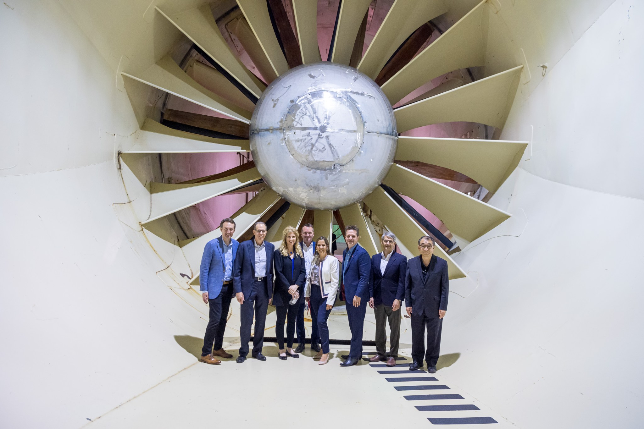 NAC Committee members from the May 2019 meeting at Glenn Research Center standing in a wind tunnel.