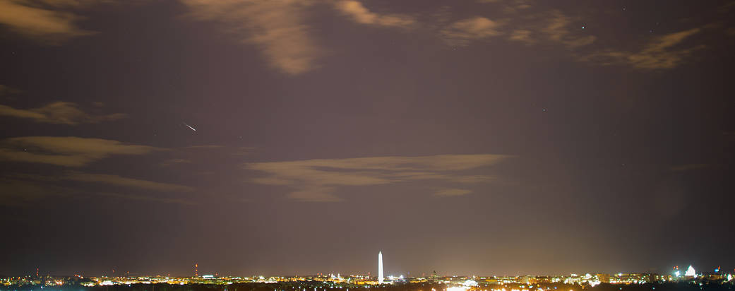 Meteor streaks across the sky above Washington, DC during the annual Perseid meteor shower