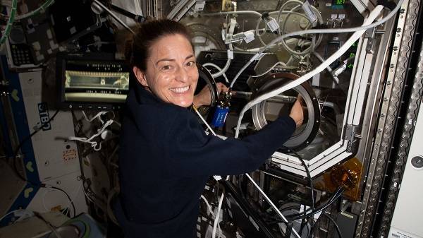 image of an astronaut working with an experiment using a science glovebox