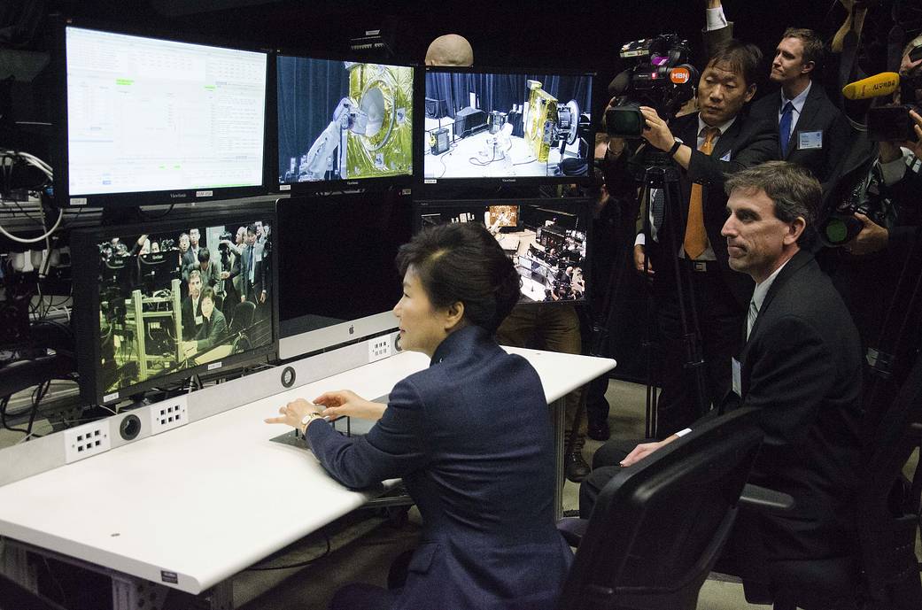 woman and man at desk with lots of monitors